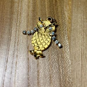 Tiny gold toned owl pendant